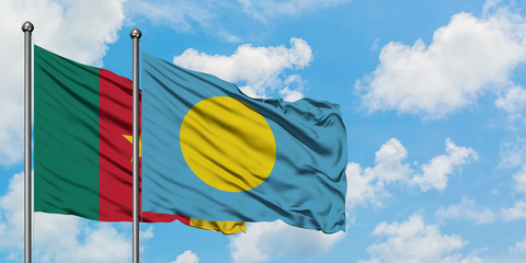 Cameroon and Palau flag waving in the wind against white cloudy blue sky together. Diplomacy concept, international relations.