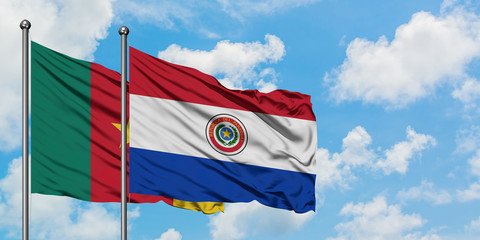 Cameroon and Paraguay flag waving in the wind against white cloudy blue sky together. Diplomacy concept, international relations.