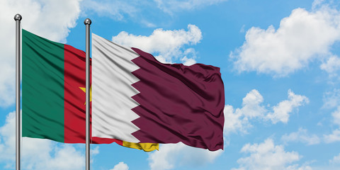 Cameroon and Qatar flag waving in the wind against white cloudy blue sky together. Diplomacy concept, international relations.