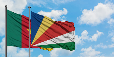 Cameroon and Seychelles flag waving in the wind against white cloudy blue sky together. Diplomacy concept, international relations.