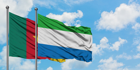 Cameroon and Sierra Leone flag waving in the wind against white cloudy blue sky together. Diplomacy concept, international relations.