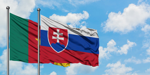 Cameroon and Slovakia flag waving in the wind against white cloudy blue sky together. Diplomacy concept, international relations.