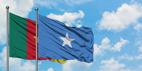 Cameroon and Somalia flag waving in the wind against white cloudy blue sky together. Diplomacy concept, international relations.