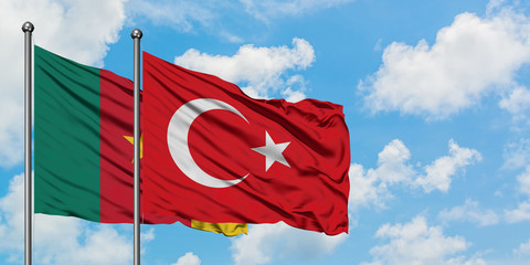 Cameroon and Turkey flag waving in the wind against white cloudy blue sky together. Diplomacy concept, international relations.