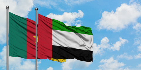 Cameroon and United Arab Emirates flag waving in the wind against white cloudy blue sky together. Diplomacy concept, international relations.