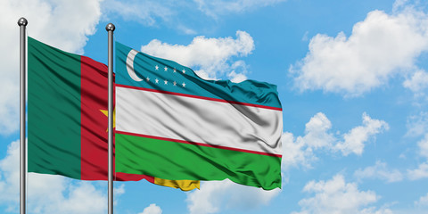 Cameroon and Uzbekistan flag waving in the wind against white cloudy blue sky together. Diplomacy concept, international relations.