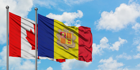 Canada and Andorra flag waving in the wind against white cloudy blue sky together. Diplomacy concept, international relations.