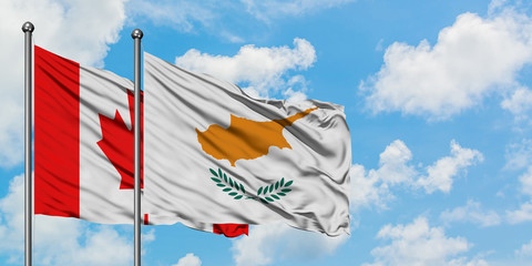 Canada and Cyprus flag waving in the wind against white cloudy blue sky together. Diplomacy concept, international relations.