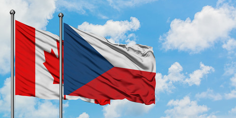 Canada and Czech Republic flag waving in the wind against white cloudy blue sky together. Diplomacy concept, international relations.