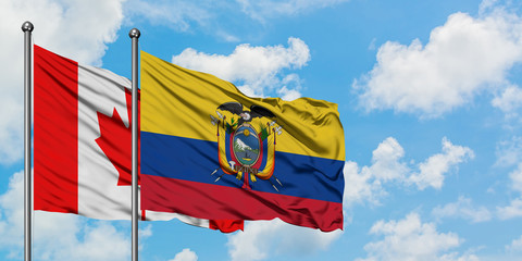 Canada and Ecuador flag waving in the wind against white cloudy blue sky together. Diplomacy concept, international relations.