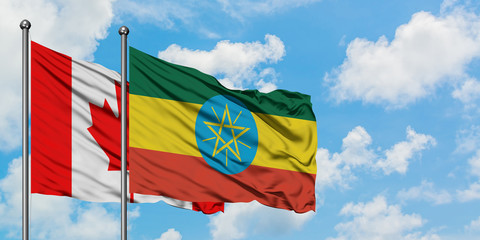 Canada and Ethiopia flag waving in the wind against white cloudy blue sky together. Diplomacy concept, international relations.