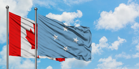 Canada and Micronesia flag waving in the wind against white cloudy blue sky together. Diplomacy concept, international relations.
