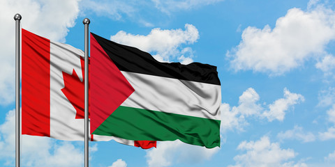 Canada and Palestine flag waving in the wind against white cloudy blue sky together. Diplomacy concept, international relations.