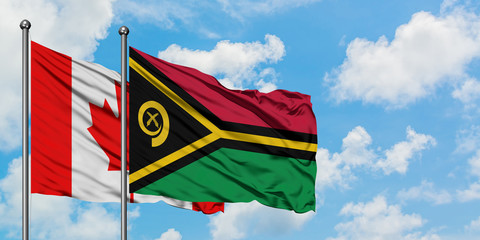 Canada and Vanuatu flag waving in the wind against white cloudy blue sky together. Diplomacy concept, international relations.