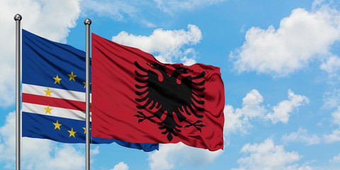 Cape Verde and Albania flag waving in the wind against white cloudy blue sky together. Diplomacy concept, international relations.