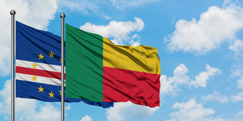 Cape Verde and Benin flag waving in the wind against white cloudy blue sky together. Diplomacy concept, international relations.