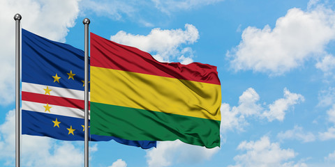 Cape Verde and Bolivia flag waving in the wind against white cloudy blue sky together. Diplomacy concept, international relations.