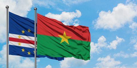 Cape Verde and Burkina Faso flag waving in the wind against white cloudy blue sky together. Diplomacy concept, international relations.