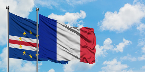 Cape Verde and France flag waving in the wind against white cloudy blue sky together. Diplomacy concept, international relations.