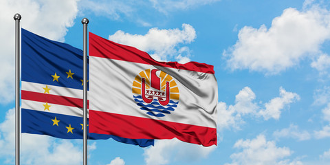 Cape Verde and French Polynesia flag waving in the wind against white cloudy blue sky together. Diplomacy concept, international relations.