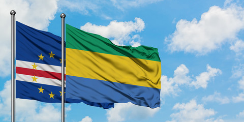 Cape Verde and Gabon flag waving in the wind against white cloudy blue sky together. Diplomacy concept, international relations.