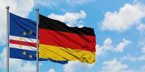 Cape Verde and Germany flag waving in the wind against white cloudy blue sky together. Diplomacy concept, international relations.