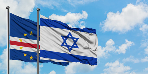 Cape Verde and Israel flag waving in the wind against white cloudy blue sky together. Diplomacy concept, international relations.