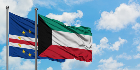 Cape Verde and Kuwait flag waving in the wind against white cloudy blue sky together. Diplomacy concept, international relations.
