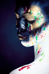 woman with creative makeup closeup like drops of colors, facepaint close up halloween