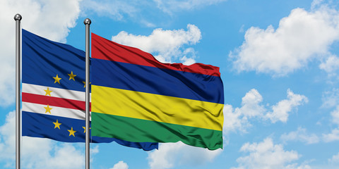 Cape Verde and Mauritius flag waving in the wind against white cloudy blue sky together. Diplomacy concept, international relations.