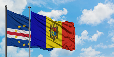 Cape Verde and Moldova flag waving in the wind against white cloudy blue sky together. Diplomacy...