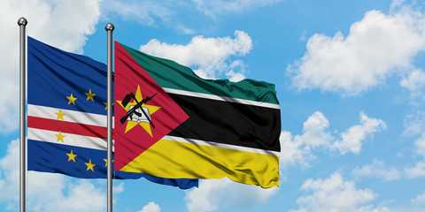 Cape Verde and Mozambique flag waving in the wind against white cloudy blue sky together. Diplomacy concept, international relations.