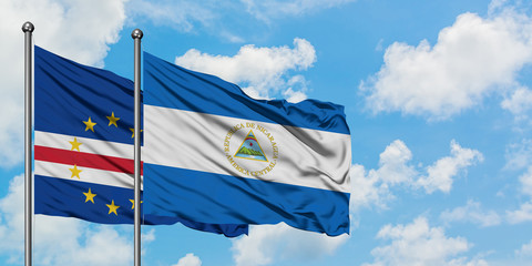 Cape Verde and Nicaragua flag waving in the wind against white cloudy blue sky together. Diplomacy concept, international relations.