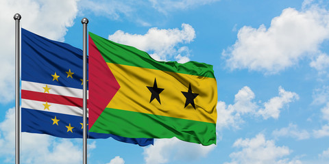 Cape Verde and Sao Tome And Principe flag waving in the wind against white cloudy blue sky together. Diplomacy concept, international relations.