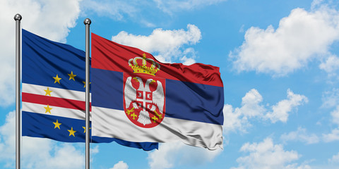 Cape Verde and Serbia flag waving in the wind against white cloudy blue sky together. Diplomacy concept, international relations.