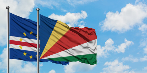 Cape Verde and Seychelles flag waving in the wind against white cloudy blue sky together. Diplomacy concept, international relations.
