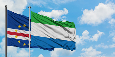 Cape Verde and Sierra Leone flag waving in the wind against white cloudy blue sky together. Diplomacy concept, international relations.