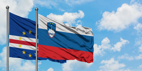 Cape Verde and Slovenia flag waving in the wind against white cloudy blue sky together. Diplomacy concept, international relations.