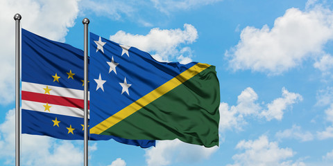 Cape Verde and Solomon Islands flag waving in the wind against white cloudy blue sky together. Diplomacy concept, international relations.