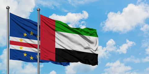 Cape Verde and United Arab Emirates flag waving in the wind against white cloudy blue sky together. Diplomacy concept, international relations.