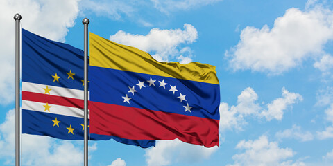 Cape Verde and Venezuela flag waving in the wind against white cloudy blue sky together. Diplomacy concept, international relations.