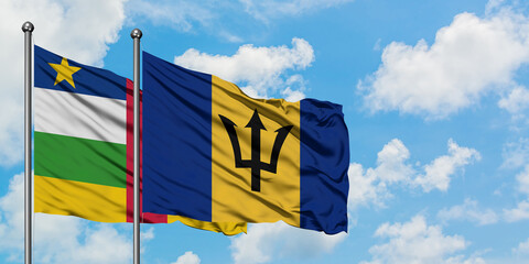 Central African Republic and Barbados flag waving in the wind against white cloudy blue sky...