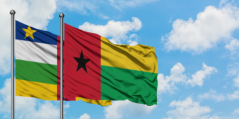 Central African Republic and Guinea Bissau flag waving in the wind against white cloudy blue sky together. Diplomacy concept, international relations.