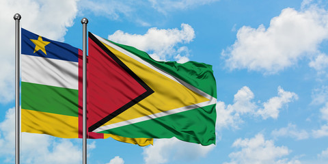 Central African Republic and Guyana flag waving in the wind against white cloudy blue sky together. Diplomacy concept, international relations.