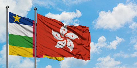 Central African Republic and Hong Kong flag waving in the wind against white cloudy blue sky together. Diplomacy concept, international relations.