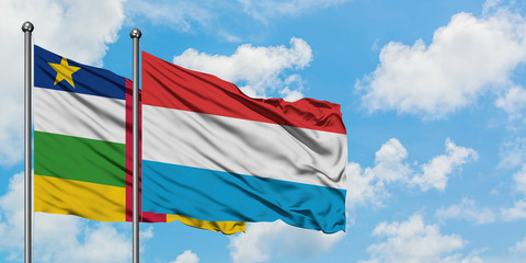 Central African Republic and Luxembourg flag waving in the wind against white cloudy blue sky together. Diplomacy concept, international relations.