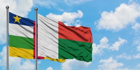 Central African Republic and Madagascar flag waving in the wind against white cloudy blue sky together. Diplomacy concept, international relations.