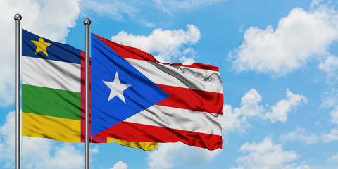 Central African Republic and Puerto Rico flag waving in the wind against white cloudy blue sky together. Diplomacy concept, international relations.