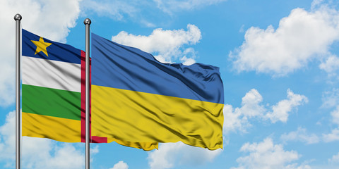 Central African Republic and Ukraine flag waving in the wind against white cloudy blue sky together. Diplomacy concept, international relations.