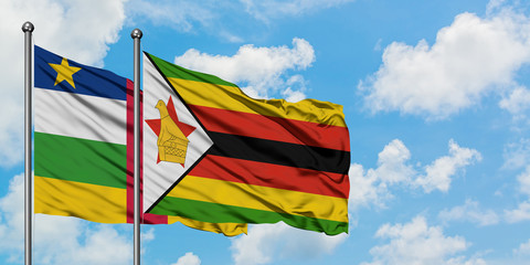 Central African Republic and Zimbabwe flag waving in the wind against white cloudy blue sky together. Diplomacy concept, international relations.